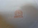 a white plate with a brown design on it