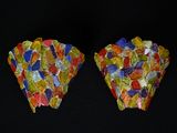 une paire de pierres multicolores posées sur une surface noire, avec un fond noir