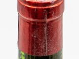 a bottle of wine that has a red cap on it