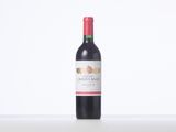 a bottle of red wine sitting on top of a white table