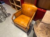 a brown chair that is sitting in a room