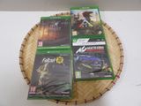 four video games on a basket on a table