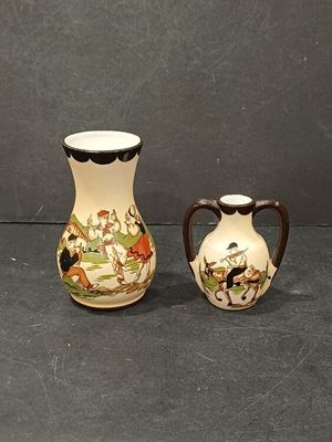 two small vases sitting next to each other on a table