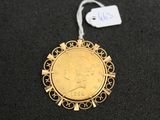 a close up of a gold coin with a tag on it