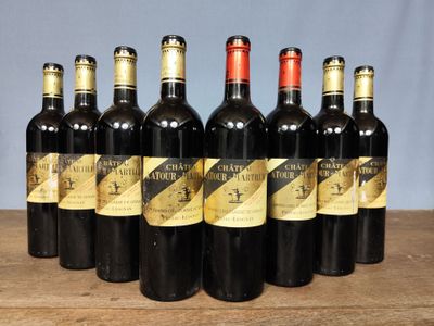 six bottles of wine are lined up in a row on a table