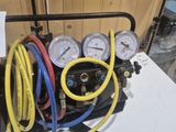 a air compressor with gauges and hoses on a table