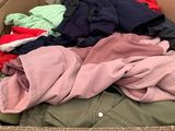 a cardboard box filled with lots of clothes and a price tag