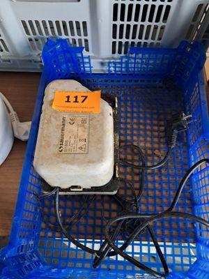a blue basket with a computer and wires in it