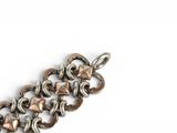 an image of a close up of a bracelet on a white surface