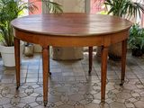 a wooden table that is sitting on a tiled floor