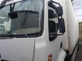 a white truck that is parked next to a building