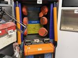 a game machine that is sitting in the corner of a room