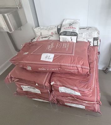 many bags of food sitting on top of a pile of bags