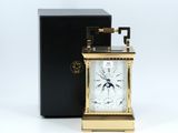 an image of a gold clock with a black box on a white background