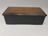 an old wooden box sitting on top of a white table