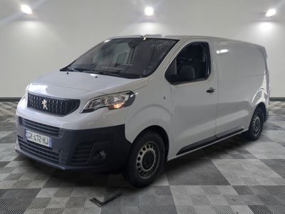 the white van is parked in a large room with a checkered floor