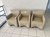 three chairs sitting next to each other on a tiled floor