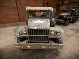 an old military truck that is parked in a garage