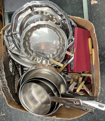 a cardboard box filled with a variety of kitchen utensils