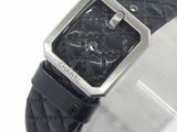 a close up of a watch with a black leather band