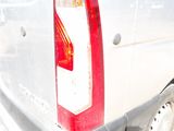 a white truck with a red tail light on it