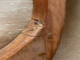 a close up of a wooden frame with a clock on it