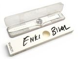 a watch in a plastic box with a name tag on it