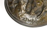 a silver coin with a picture of a man riding a horse