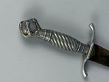 a sword that is laying on a white surface