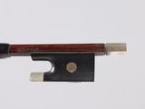 a violin bow that is attached to a piece of wood