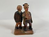 two figurines of two men standing next to each other