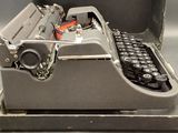 an old typewriter sitting in a case on a table