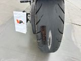 a close up of a motorcycle tire with a tag on it