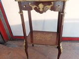 a small wooden table with a shelf on it