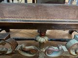 a wooden table with a wicker top on a wooden floor