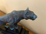 a statue of a dog that is standing on a table