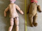 two dolls that are next to each other on the floor