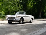 a white car that is driving down the street