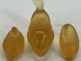 three pieces of glass sitting on a white surface
