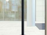 an image of a black coat rack in front of a window