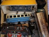a cardboard box filled with toy trains and other toys