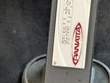 a parking meter with a sign on it in a parking lot