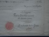 an old document with a red seal on it sitting on top of a table