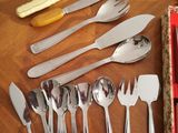 a lot of silverware on a table with a red box