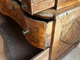 a wooden dresser with two drawers on top of it