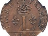 an old coin with a crown on it on a white surface