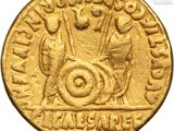 a close up of a gold coin with a man on it