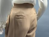 an image of a mannequin wearing a white shirt and tan pants
