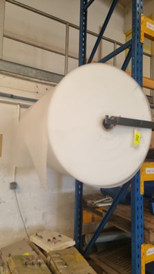 a large roll of paper on a rack in a warehouse