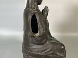 bronze statue of a woman with a bird on her head